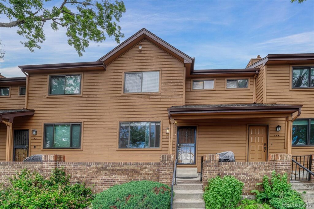 A large brown house with a lot of windows